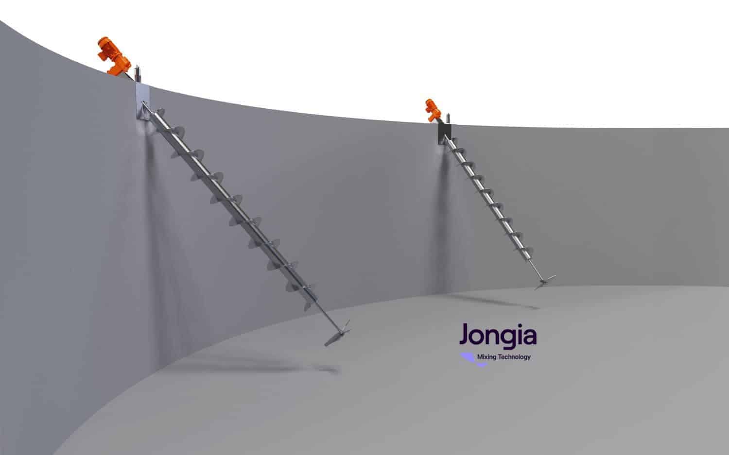 Two metal auger-style mixers are installed diagonally inside a large, upright, gray cylindrical tank. Each mixer is mounted at an angle through the tank’s upper wall, with orange motors attached on top. The tank interior is empty and well-lit.